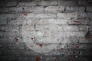 Old brick wall with inscriptions of the names