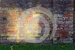 Old brick wall with large yellow sun spot