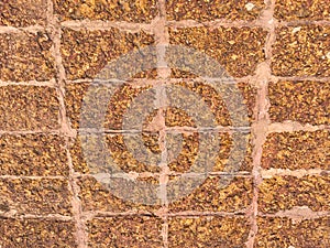 Old brick wall, old texture of red stone blocks closeup