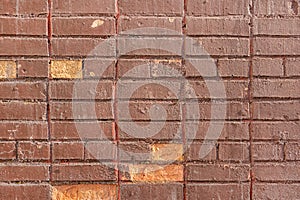 Old brick wall is painted with brown paint. Blank background with brickwork texture.