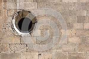 Old brick wall with round window