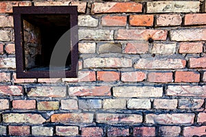 Old brick wall with a small window