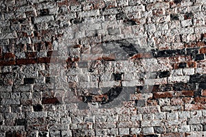 Old brick wall with some ruined white and black bricks