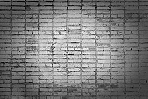 Old brick wall, with stains. Texture of masonry. Blank background of gray bricks with vignette.