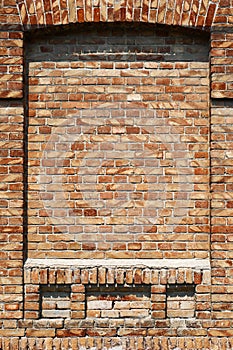 Old brick wall for texture or background, red and brown color, architectural elements as a brick filled window