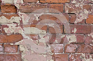 Old brick wall texture. Peeling painted surface. Grunge brickwall. Red stone background with damaged plaster. Abstract