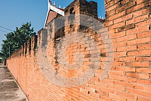 The old brick wall of Thai temple. Old and dirty wall.