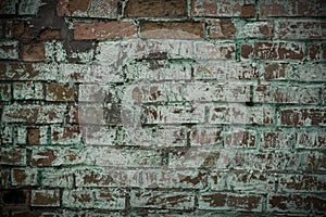 Old brick wall with traces of green paint