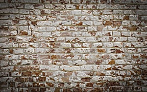 Old brick wall with white paint background texture close up