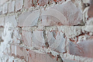 Old brick wall with white paint background texture close up. Side view, low depth of field.