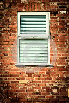 Old brick wall with window blinds