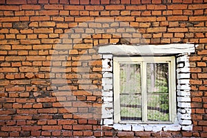 Old brick wall with wooden window