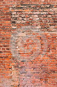 The old brick walls. A fragment of the wall of the building