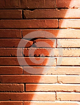 Old brick walls are red, orange and shadow from the sunshine