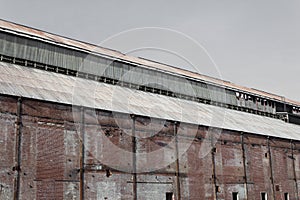 Old brick warehouse building with corrugated metal roof