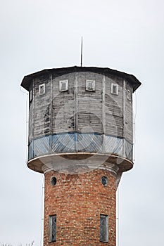 Old brick watertower with wood top, located in small countryside city centre