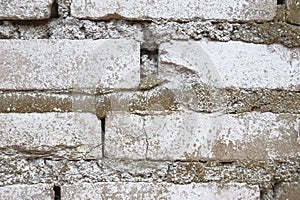 Old brickwork. Brick wall. White silicate brick. Crumbling brick from time to time