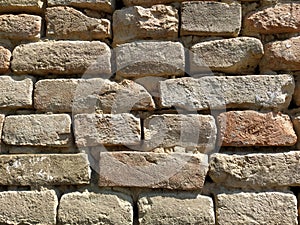 Old brickwork. Wall of an old residential building. Brick wall made of bright red bricks. Lightly worn surface. Neat masonry,