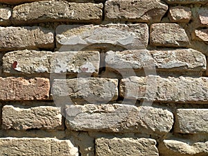 Old brickwork. Wall of an old residential building. Brick wall made of bright red bricks. Lightly worn surface. Neat masonry,