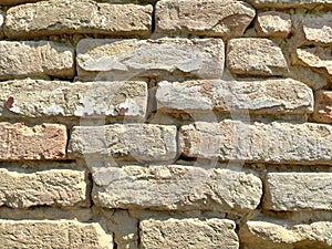 Old brickwork. Wall of an old residential building. Brick wall made of bright red bricks. Lightly worn surface. Neat masonry,