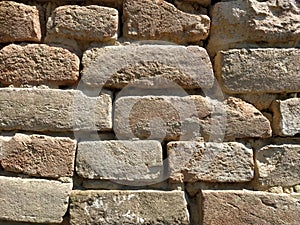 Old brickwork. Wall of an old residential building. Brick wall made of bright red bricks. Lightly worn surface. Neat masonry,