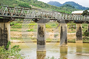 Old bridge crossing river in Tay Nguyen, central highlands of Vietnam