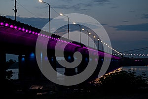 Old bridge in the evening with backlight in the city of Dnieper in Ukraine