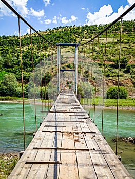 Old bridge over Black Drin river in Albania in summer photo