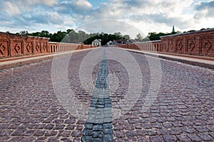 Old bridge over the river with pavement.