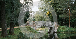 Old bridge over the river in the summer park Gatchina.