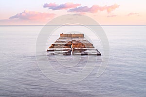 Old bridge pier against beautiful sunset sky use for natural background ,backdrop and multipurpose sea scene