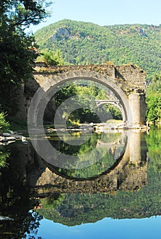 Old Bridge reflecting in the river Tarn