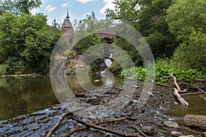 Old bridge, waterfall and tree branches- Elzbach creek, Germany