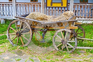 Old, broken, abandoned, cart with hay. Close-up