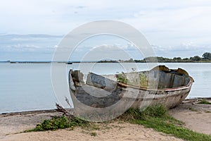 An old broken boat on the shore