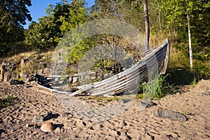 Old broken boat on the shore.