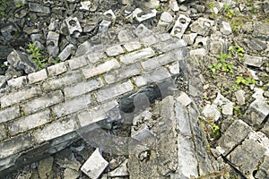 Old broken brick wall with moss