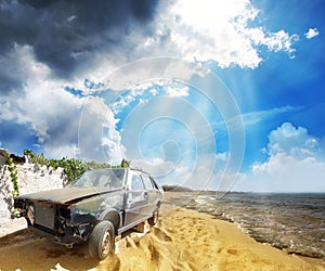 An old broken car on the beach
