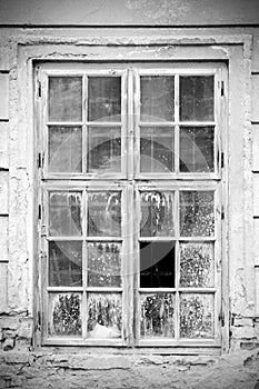 Old broken closed window in black and white