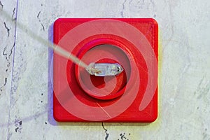 Old broken electrical socket red of wall. A violation electrical safety