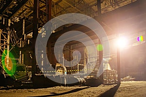 Old broken empty abandoned industrial building with scrap metal at night