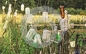 Old broken garden fence with plastic bottles