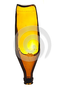 Old broken glass beer bottle of brown color isolated on a white background