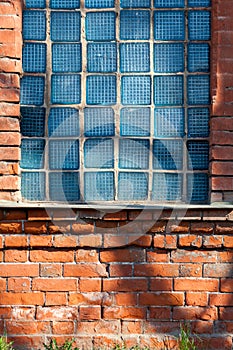 Old broken glass blocks in the brick walls