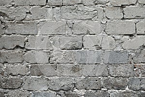 Old broken gray brick wall background. Old gray damaged brick wall texture, Gray brick backdrop and texture for text or image.