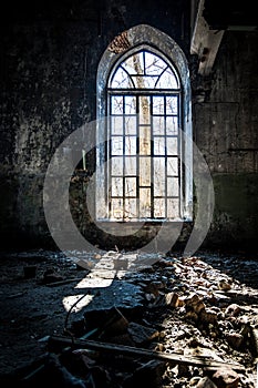 Old broken lancet window inside abandoned building