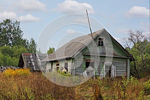 Old broken log wooden house in Russian village