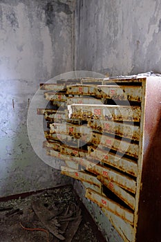 An old broken mailbox in an apartment building