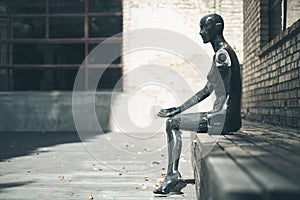 Old broken mannequin sitting outdoors and looking useless