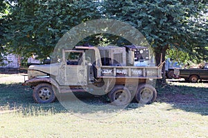 Old, broken military trucks were left unused in the outdoors.